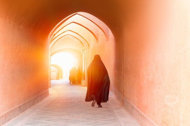Muslim,Woman,Walking,On,The,Narrow,Street,Of,Old,Adobe